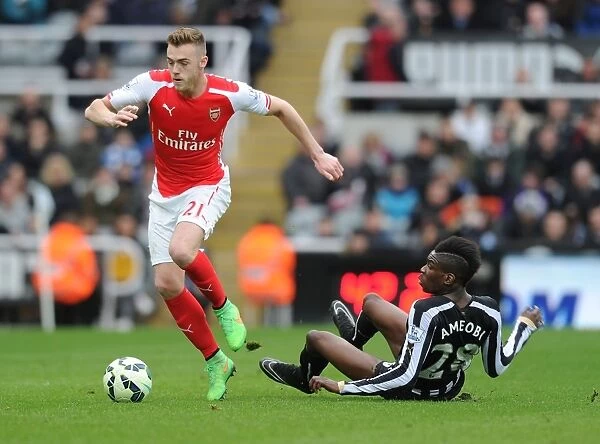Arsenal's Calum Chambers Outmaneuvers Newcastle's Sami Ameobi in Premier League Clash