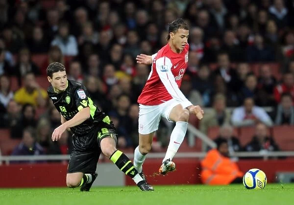 Arsenal's Chamakh Outmaneuvers Leeds O'Dea in FA Cup Clash