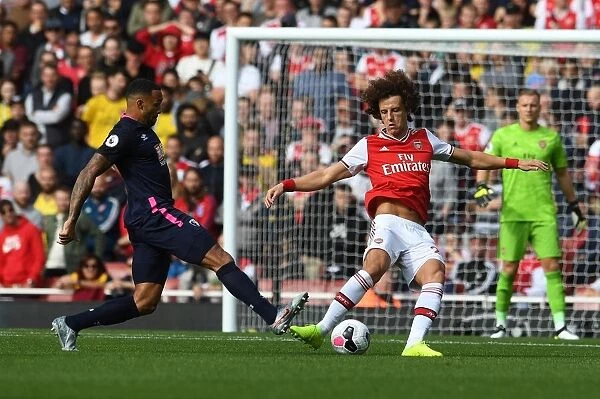 Arsenal's David Luiz Evades Pressure from Bournemouth's Callum Wilson During Premier League Clash