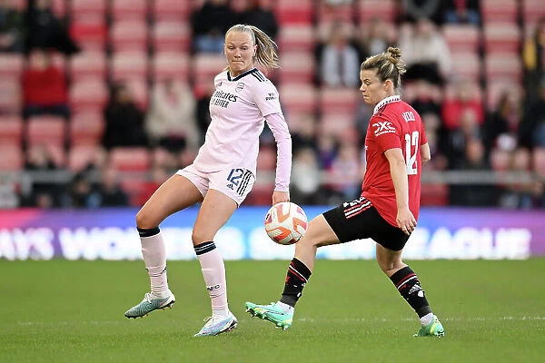 Arsenal's Frida Maanum Faces Pressure from Manchester United's Hayley Ladd in FA Women's Super League Clash