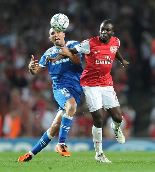 Arsenal's Frimpong Wins Ball from Olympiacos Djebbour in UCL Clash