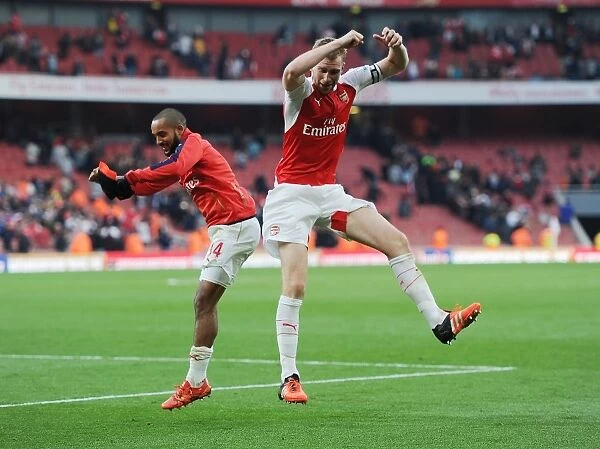 Arsenal's Glory: Theo Walcott and Per Mertesacker Celebrate Hard-Fought Victory Over Manchester United (2015 / 16 Premier League)