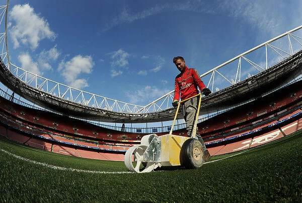 Arsenal's Groundsman Readies Emirates Turf for Arsenal FC vs. FC Bayern Munich: UEFA Champions League Showdown