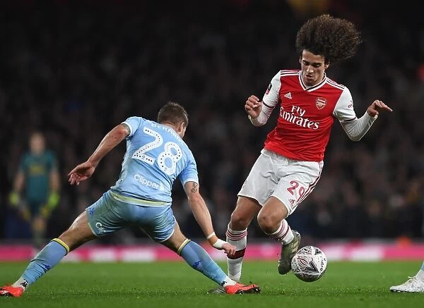 Arsenal's Guendouzi Fights Off Leeds Defenders in FA Cup Showdown