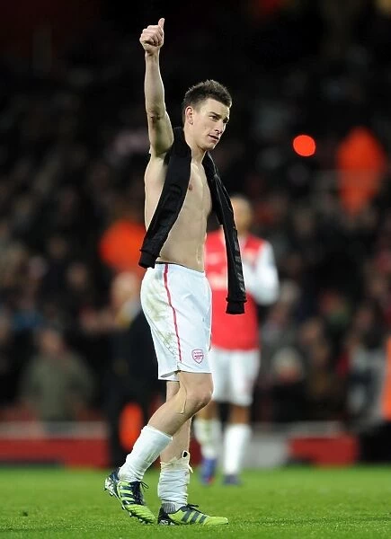 Arsenal's Historic 3-0 Victory Over AC Milan: Laurent Koscielny Celebrates with Fans in the Emirates Stadium