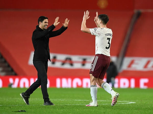 Arsenal's Historic Victory at Old Trafford: Mikel Arteta and Kieran Tierney Celebrate Amidst Empty Stands (Manchester United vs Arsenal, 2020-21)