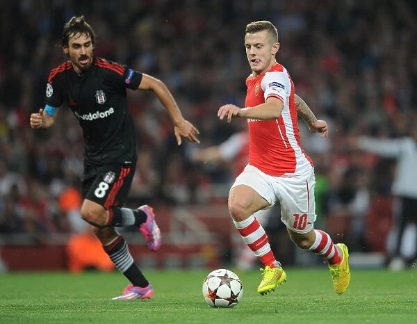 Arsenal's Jack Wilshere Clashes with Besiktas Veli Kavlak in UEFA Champions League Qualifier