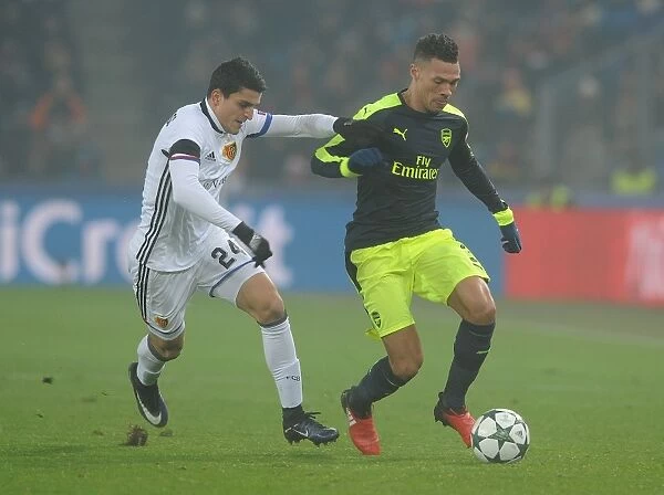 Arsenal's Kieran Gibbs Clashes with Basel's Mohamed Elyounoussi in 2016-17 UEFA Champions League