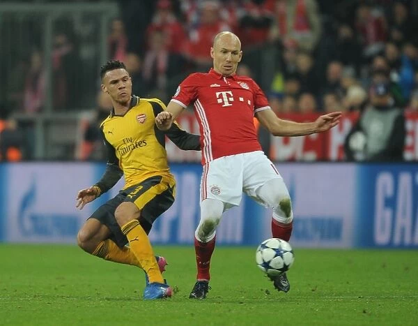 Arsenal's Kieran Gibbs Faces Off Against Bayern Munchen's Arjen Robben in Champions League Clash
