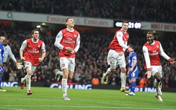 Arsenal's Koscielny, Djourou, Fabregas, and van Persie: Celebrating a 3:0 (3:1 agg) Carling Cup Semi-Final Victory over Ipswich Town