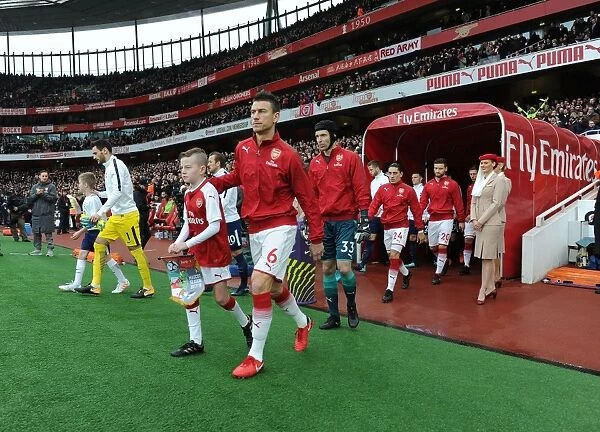 Arsenal's Laurent Koscielny Leads Team Out Against Tottenham in Premier League Clash