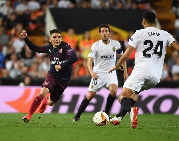 Arsenal's Lucas Torreira Clashes with Valencia's Ezequiel Garay in UEFA Europa League Semi-Final