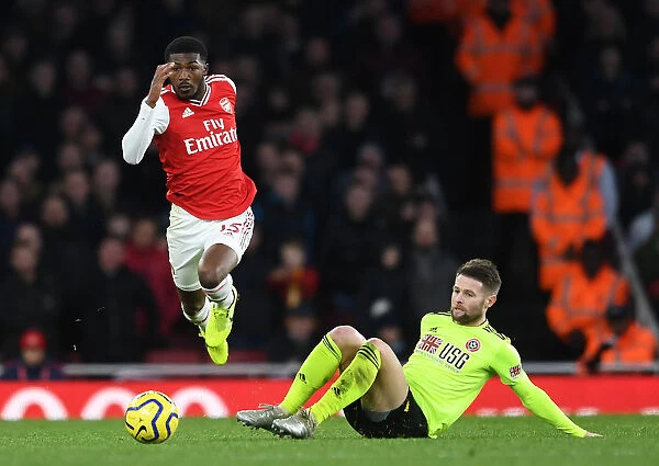 Arsenal's Maitland-Niles Outmaneuvers Sheffield United's Norwood in Premier League Clash