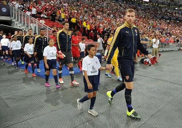 Arsenal's Per Mertesacker Leads Team Out in Arsenal v Singapore XI Match, Kallang, Singapore (July 15, 2015)