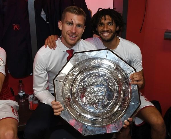 Arsenal's Per Mertesacker and Mohamed Elneny Celebrate FA Community Shield Victory with the Trophy
