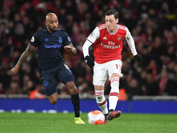 Arsenal's Mesut Ozil Clashes with Everton's Fabian Delph in Premier League Showdown