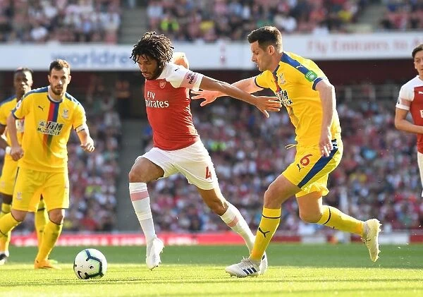 Arsenal's Mohamed Elneny Clashes with Crystal Palace's Scott Dann in Premier League Showdown