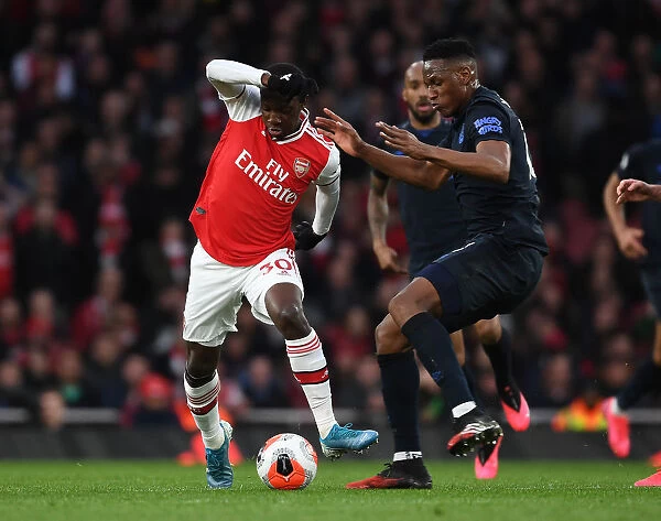 Arsenal's Nicolas Pepe Clashes with Everton's Yerry Mina in Premier League Showdown