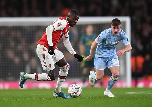 Arsenal's Nicolas Pepe Clashes with Leeds United's Robbie Gotts in FA Cup Third Round