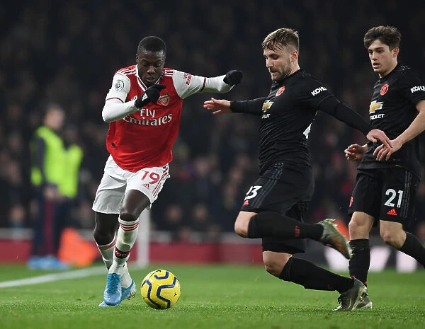 Arsenal's Nicolas Pepe Outmaneuvers Manchester United's Luke Shaw in Premier League Clash