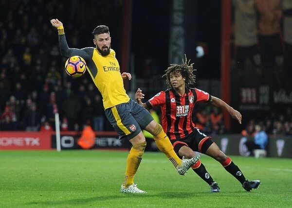 Arsenal's Olivier Giroud Faces Off Against Bournemouth's Nathan Ake in Intense Premier League Clash