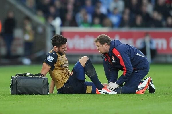 Arsenal's Olivier Giroud Receives Medical Attention from Physio Colin Lewin during Swansea Match, 2015-16