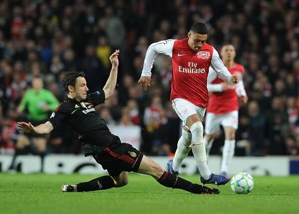 Arsenal's Oxlade-Chamberlain Outmaneuvers AC Milan's Van Bommel in Champions League Showdown