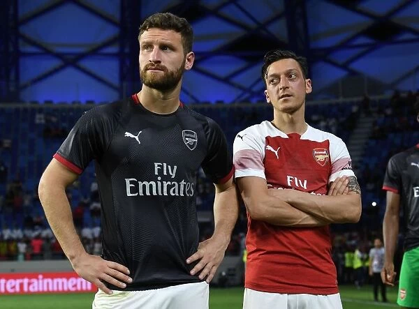 Arsenal's Ozil and Mustafi Share a Moment after Al-Nasr Friendly Match