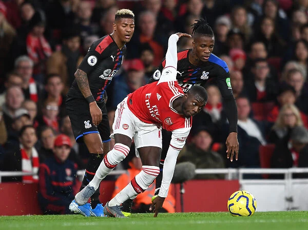 Arsenal's Pepe Clashes with Palace's Van Aanholt and Zaha during the 2019-20 Premier League Match