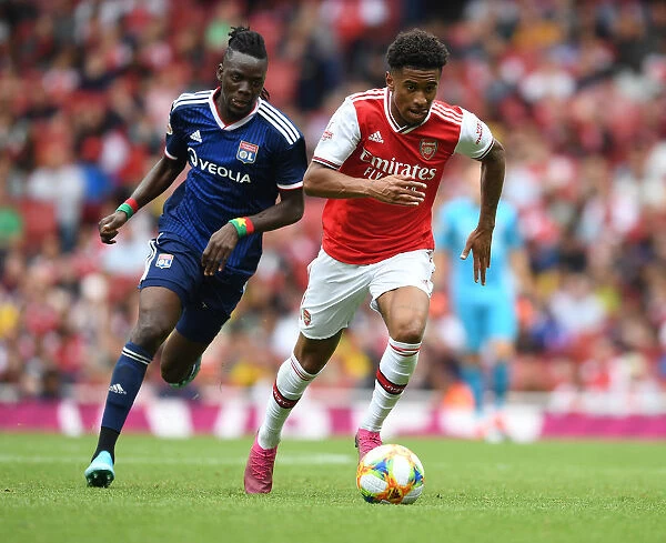 Arsenal's Reiss Nelson Outmaneuvers Lyon's Bertrand Traore at Emirates Cup