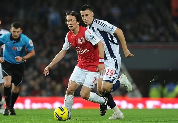 Arsenal's Rosicky Outmaneuvers West Brom's Thorne in 2011-12 Premier League Clash