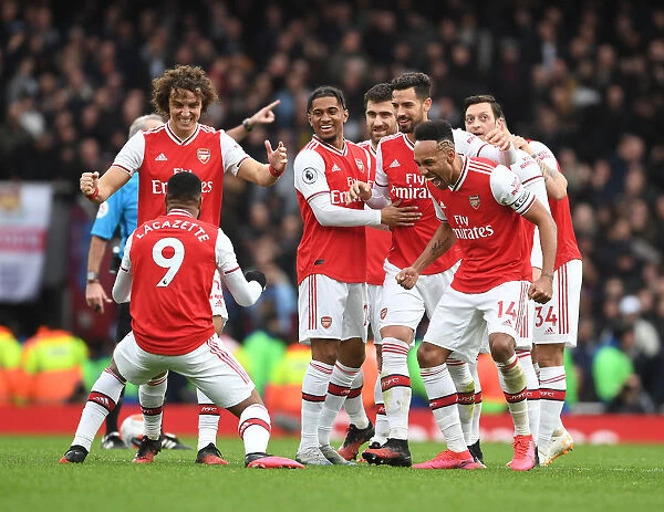 Arsenal's Star Players Celebrate Lacazette's Goal Against West Ham United in the Premier League 2019-20: A Moment of Triumph at Emirates Stadium with David Luiz, Reiss Nelson, Pablo Mari, and Pierre-Emerick Aubameyang