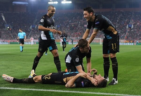 Arsenal's Star Players: Giroud, Ramsey, Ozil, and Walcott Celebrate Double Strike Against Olympiacos in the UEFA Champions League