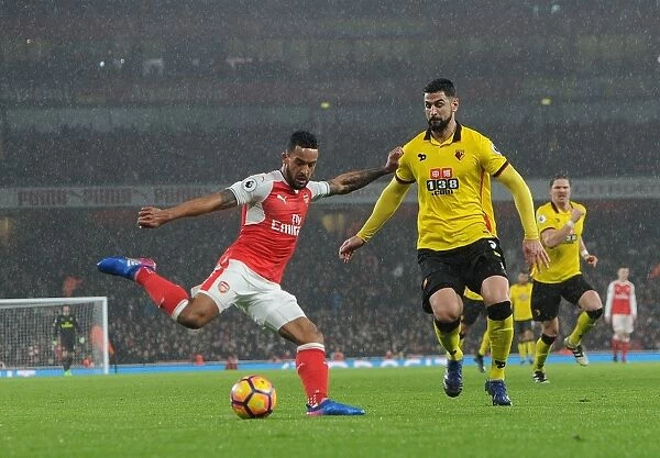 Arsenal's Theo Walcott Battles Past Watford's Miguel Britos in Premier League Clash