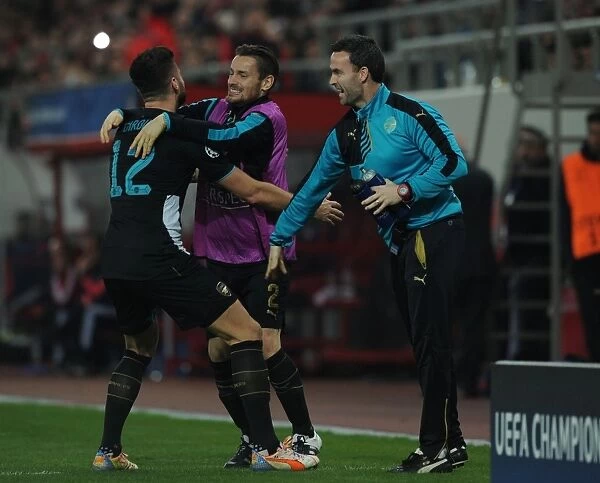 Arsenal's Triumph: Giroud, Debuchy, and Forsythe Celebrate Goals Against Olympiacos in the UEFA Champions League