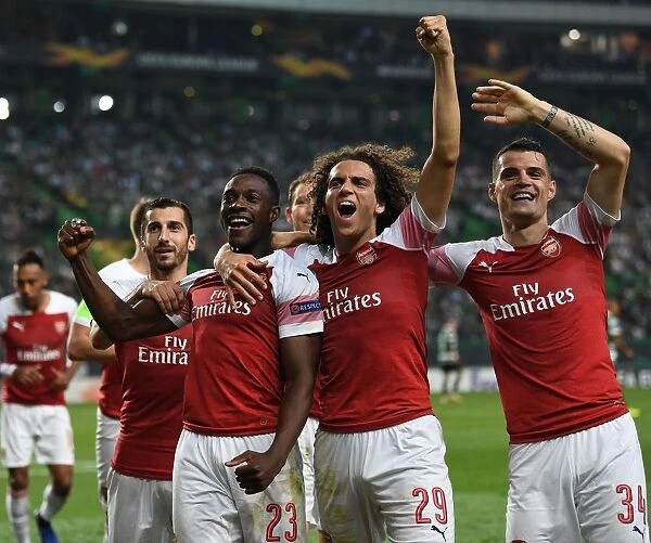 Arsenal's Triumph: Welbeck, Guendouzi, and Xhaka Celebrate Goal against Sporting Lisbon (2018-19)