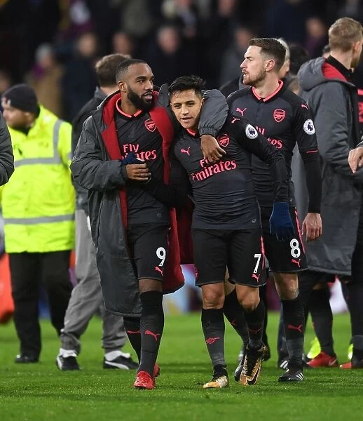 Arsenal's Unstoppable Strikers: Lacazette and Sanchez Celebrate Victory over Burnley
