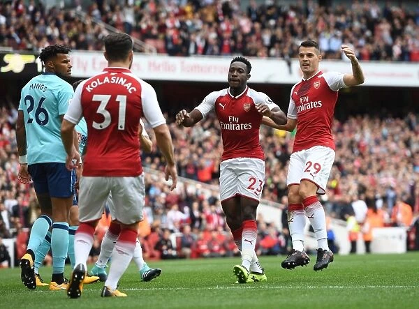 Arsenal's Winning Moment: Welbeck, Xhaka, and Kolasinac Celebrate First Goal vs. AFC Bournemouth (2017-18)