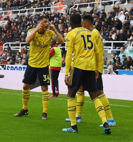 Arsenal's Xhaka, Maitland-Niles, and Aubameyang in Action against Newcastle United (2019-20)