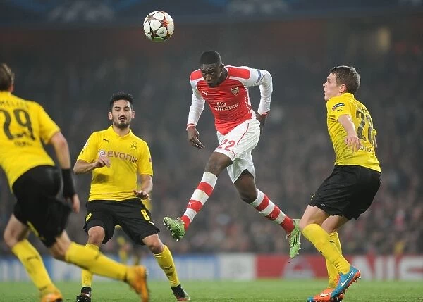 Arsenal's Yaya Sanogo Leaps Above Dortmund's Gundogan and Ginter in Champions League Clash