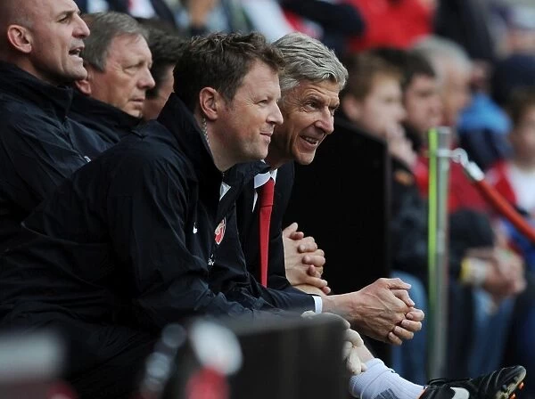 Arsene Wenger and Colin Lewin Share a Light-Hearted Moment during Arsenal's Pre-Season Match against Anderlecht (2012)