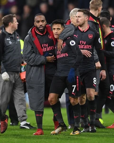 Celebrating Victory: Lacazette and Sanchez's Jubilant Moment after Arsenal's Win against Burnley