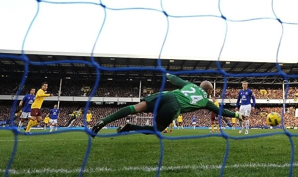Cesc Fabregas shoots past Everton goalkeeper Tim Howard to score the 2nd Arsenal goal
