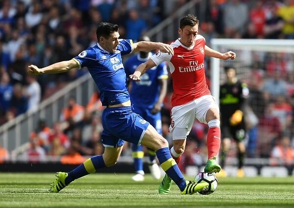 Clash of the Midfield Masters: Ozil vs. Barry