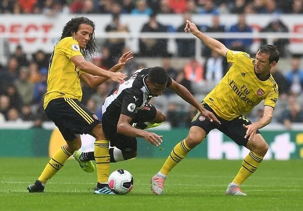 Clash at St. James Park: Arsenal's Guendouzi and Monreal Face Off Against Newcastle's Hayden (Newcastle United vs Arsenal, 2019-20)