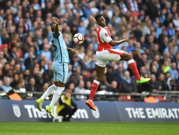 Clash at Wembley: Welbeck Leaps Over Fernandinho in FA Cup Semi-Final Showdown (Arsenal vs Manchester City)