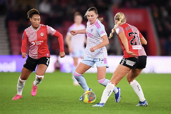 Conti Cup Clash: Southampton Women vs. Arsenal Women at St. Mary's Stadium - Arsenal's Maritz Fends Off Pressure from Southampton's Lloyd-Smith and Purfield