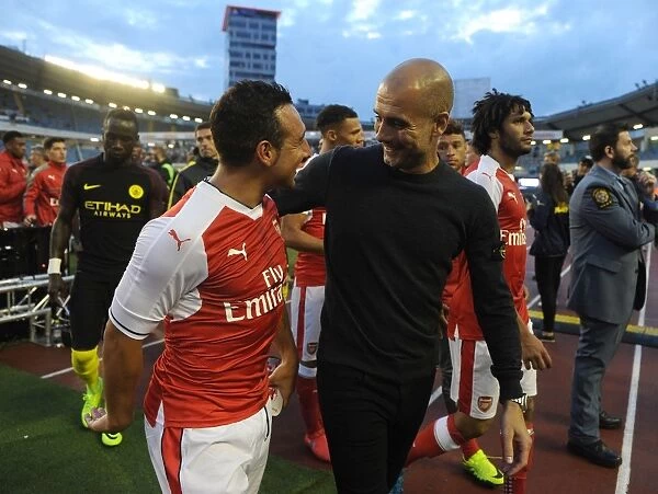 Deep in Dialogue: Santi Cazorla and Pep Guardiola Engage in Intense Conversation During Arsenal vs. Manchester City Pre-Season Friendly