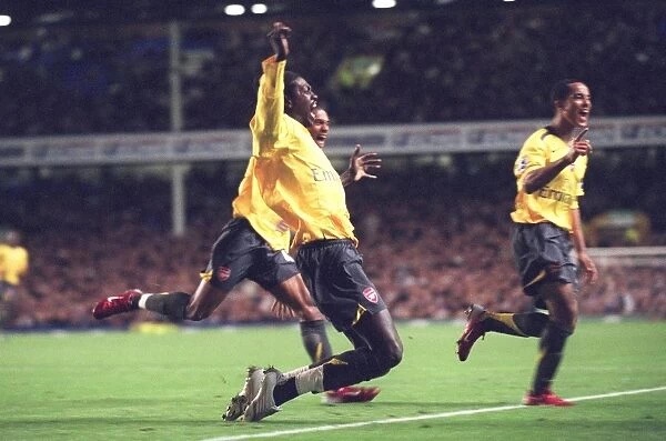 Emmanuel Adebayor celebrates scoring Arsenals goal with Armand Traore