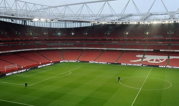The Groundsman Prepares the Emirates Pitch for Arsenal's 2:0 Quarterfinal Victory over Wigan Athletic